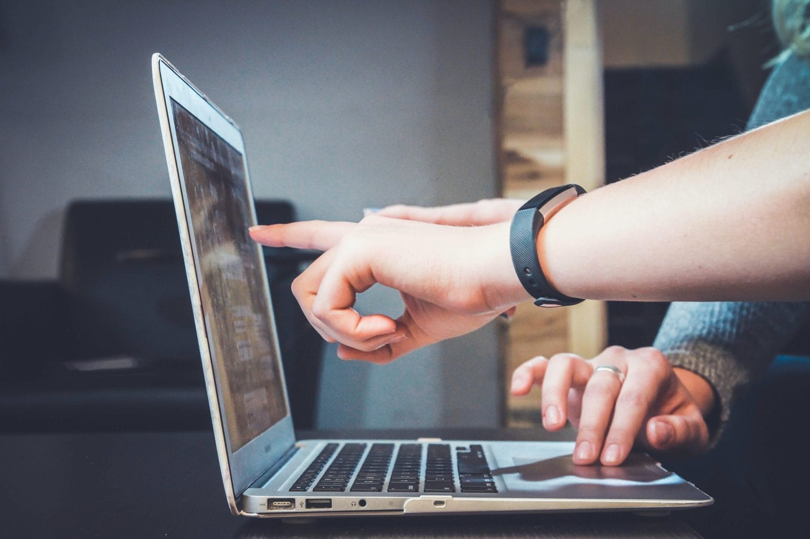 Web designer reviewing a website on a laptop screen